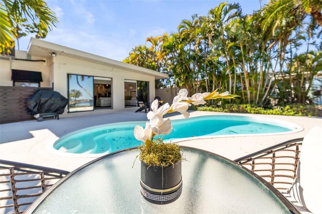 402 161st Avenue Redington Beach, FL 33708 - Photo 35 of 56 a view of a backyard with furniture and a fire pit