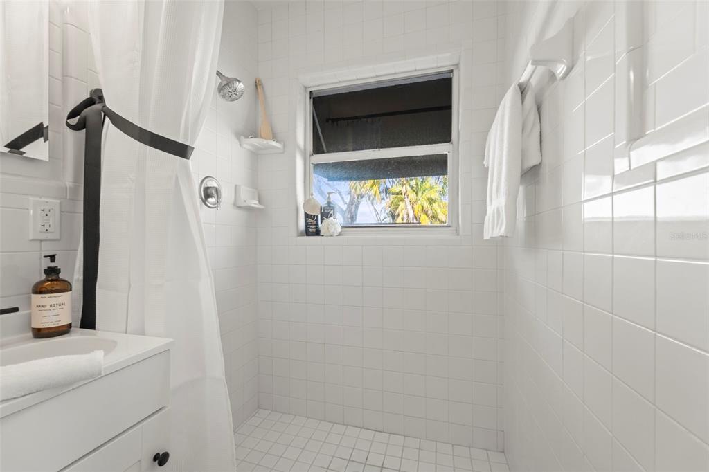 402 161st Avenue Redington Beach, FL 33708 - Photo 35 of 55 a bathroom with a sink and mirror