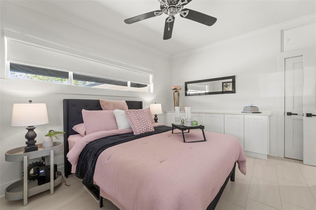 402 161st Avenue Redington Beach, FL 33708 - Photo 38 of 56 a bedroom with a bed and a chandelier