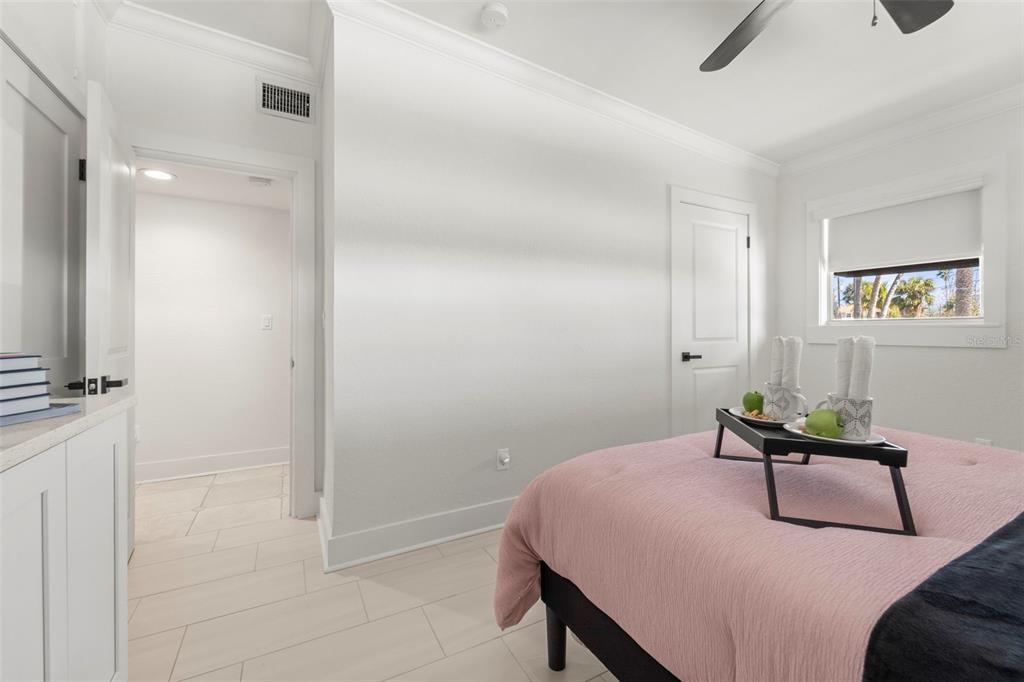 402 161st Avenue Redington Beach, FL 33708 - Photo 39 of 56 a bedroom with a bed and a chandelier