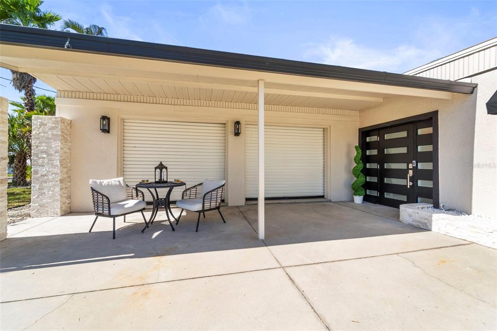 402 161st Avenue Redington Beach, FL 33708 - Photo 44 of 56 a patio with table and chairs and potted plants