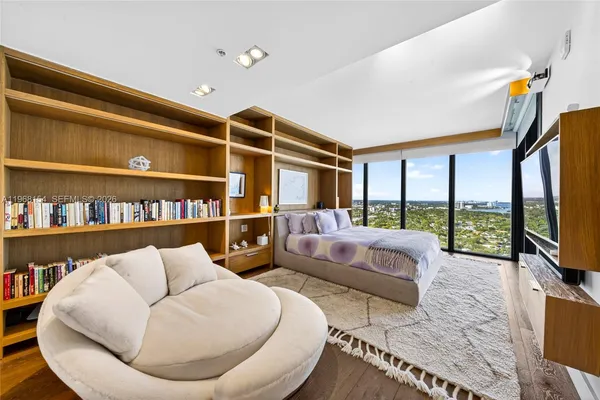 a living room with furniture and a floor to ceiling window