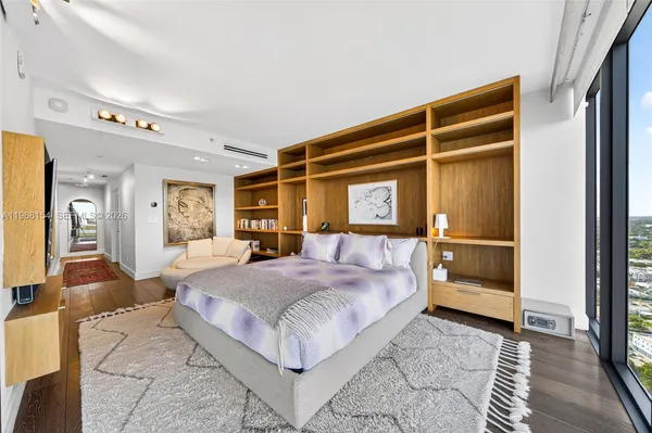 a bedroom with a large bed and a dresser