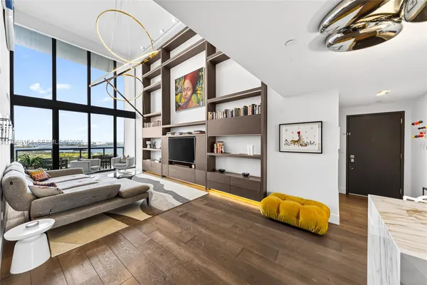 a bedroom with furniture and a large window