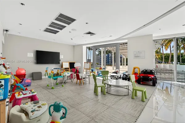 a children room with furniture and a flat screen tv
