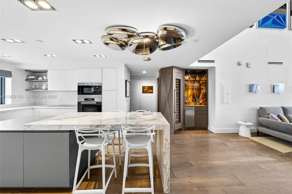 a kitchen with stainless steel appliances kitchen island granite countertop a stove a sink and a refrigerator