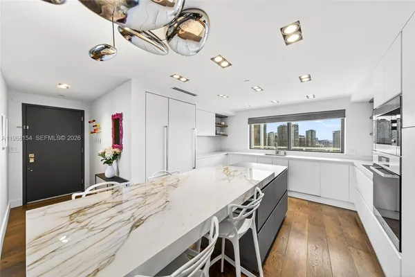 a kitchen with kitchen island and wooden floor
