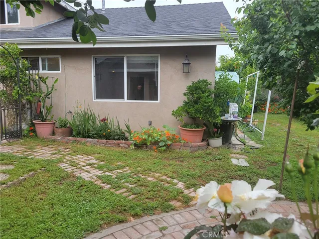 a view of flower garden with wooden fence