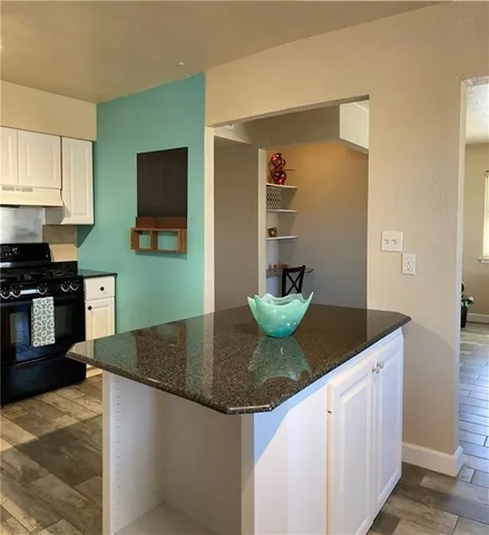 a view of kitchen and hall with wooden floor
