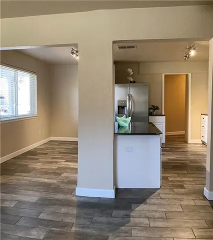 a kitchen with a refrigerator sink and cabinets