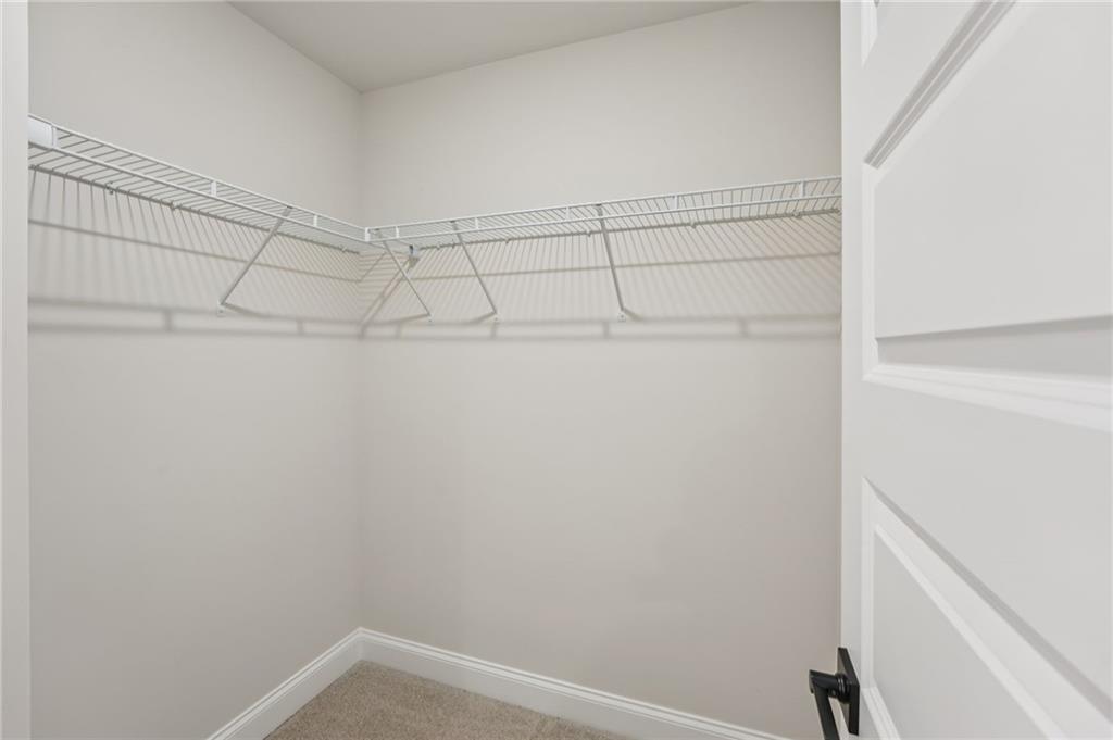 6440 Pinin Place Cumming, GA 30041 - Photo 45 of 52 a view of a room with racks on the wall