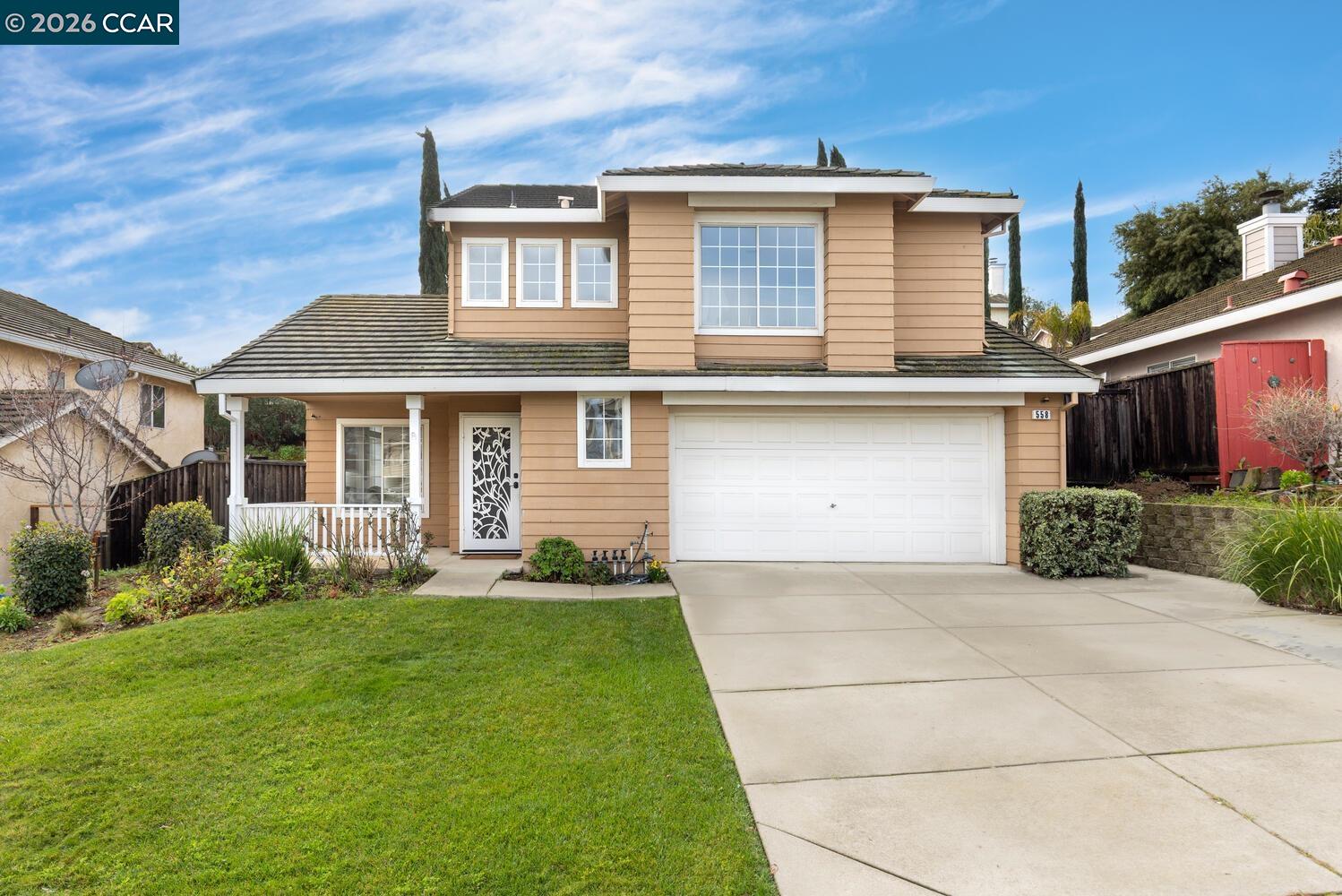 a front view of a house with a yard and garage