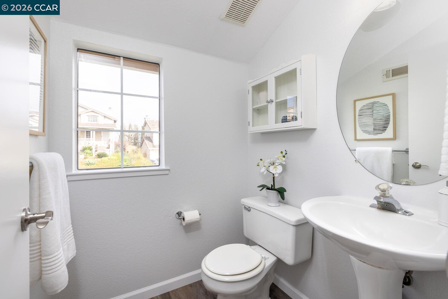 558 Fletcher Street Bay Point, CA 94565 - Photo 20 of 37 a bathroom with a sink a mirror and a toilet
