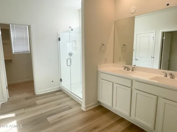 a bathroom with a double vanity sink and mirror