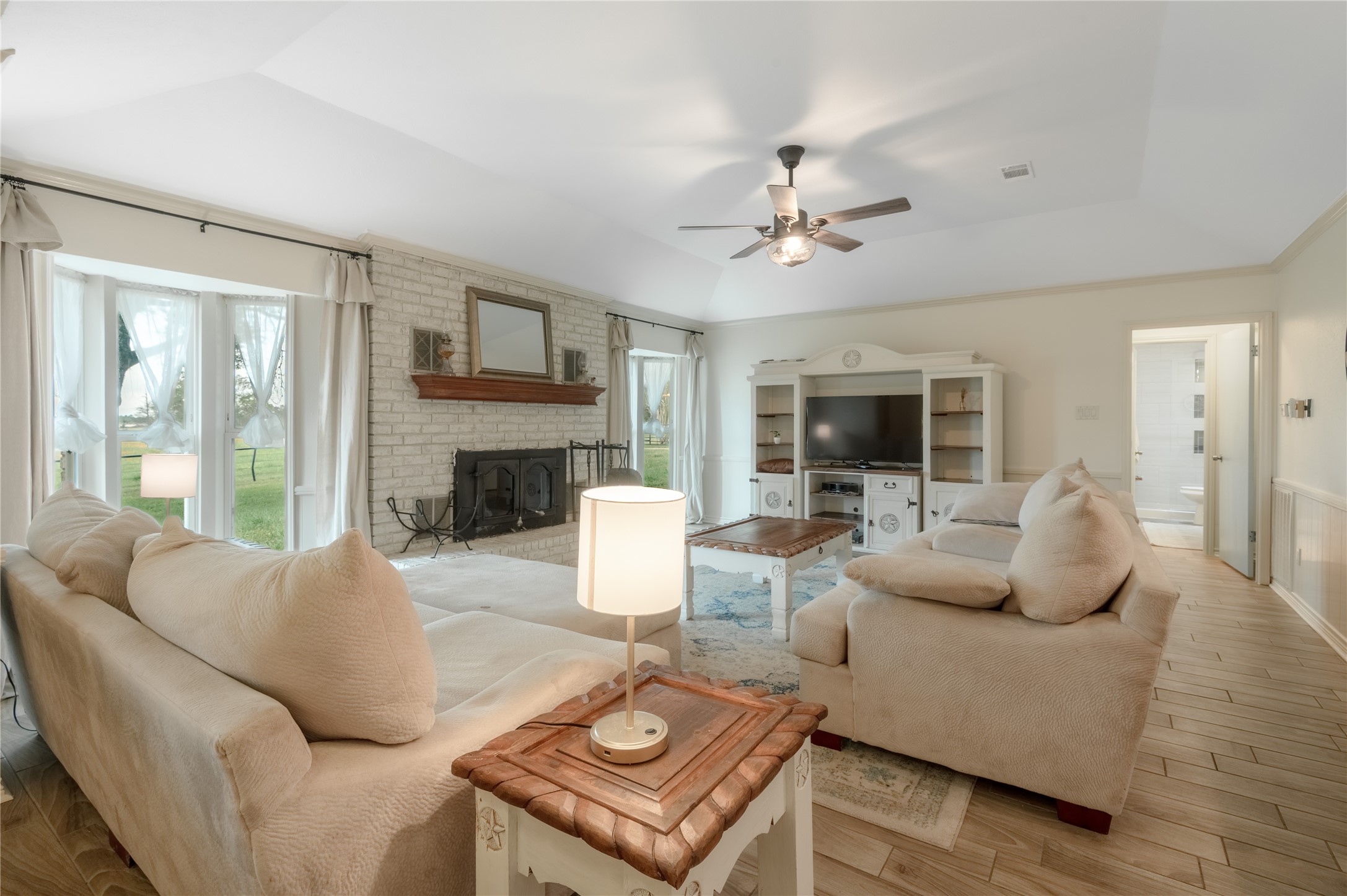 758 Wire Road Huntsville, TX 77320 - Photo 8 of 44 a living room with furniture a fireplace and a large window