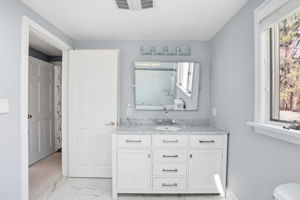 192 Prospect Street Hingham, MA 02043 - Photo 15 of 37 a bathroom with a granite countertop sink and a mirror