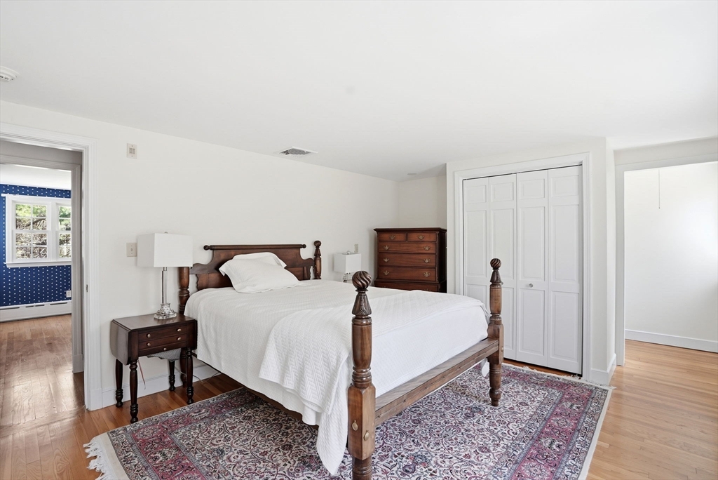192 Prospect Street Hingham, MA 02043 - Photo 16 of 37 a large bed sitting in a bedroom and a table