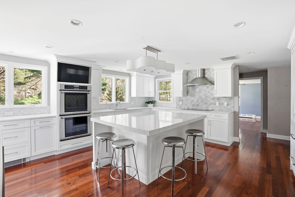 192 Prospect Street Hingham, MA 02043 - Photo 2 of 37 a kitchen with stainless steel appliances granite countertop a kitchen island hardwood floor and a sink