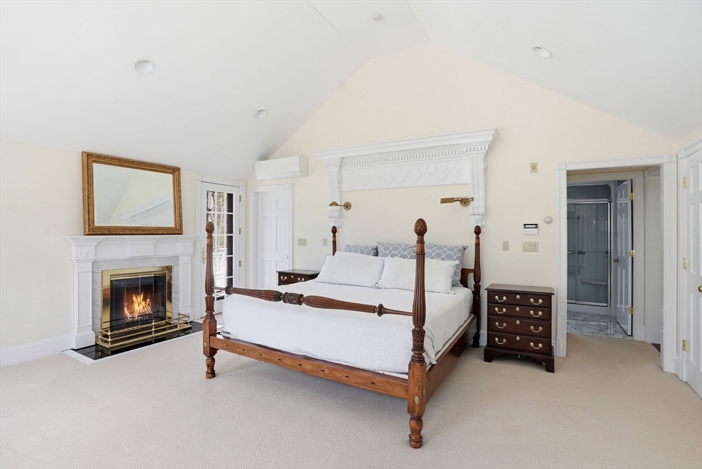 192 Prospect Street Hingham, MA 02043 - Photo 34 of 37 a bed room with a bed and a fireplace