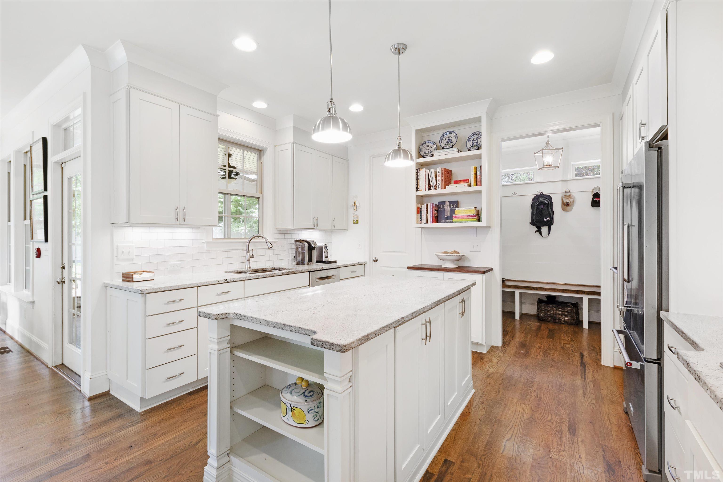 3205 Plantation Road Raleigh, NC 27609 - Photo 13 of 39 a large kitchen with a lot of counter space and wooden floor