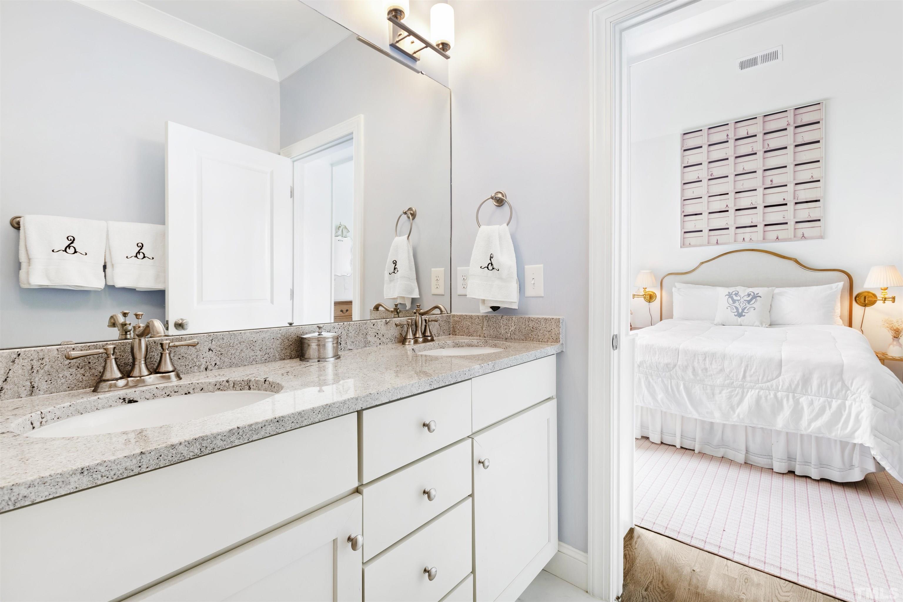 3205 Plantation Road Raleigh, NC 27609 - Photo 25 of 39 a en suite bathroom with a sink and a mirror