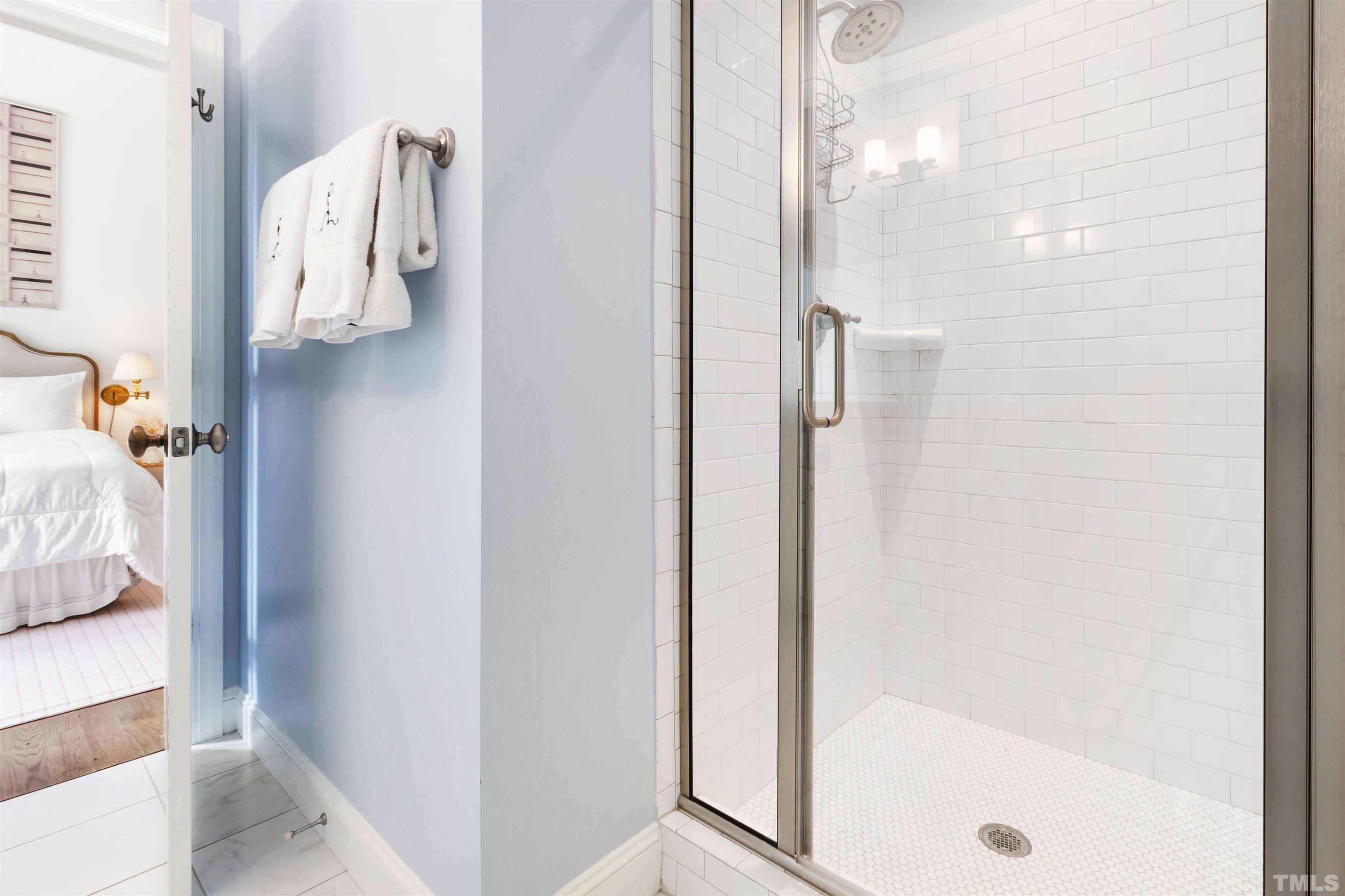 3205 Plantation Road Raleigh, NC 27609 - Photo 26 of 39 a bathroom with a shower and mirror