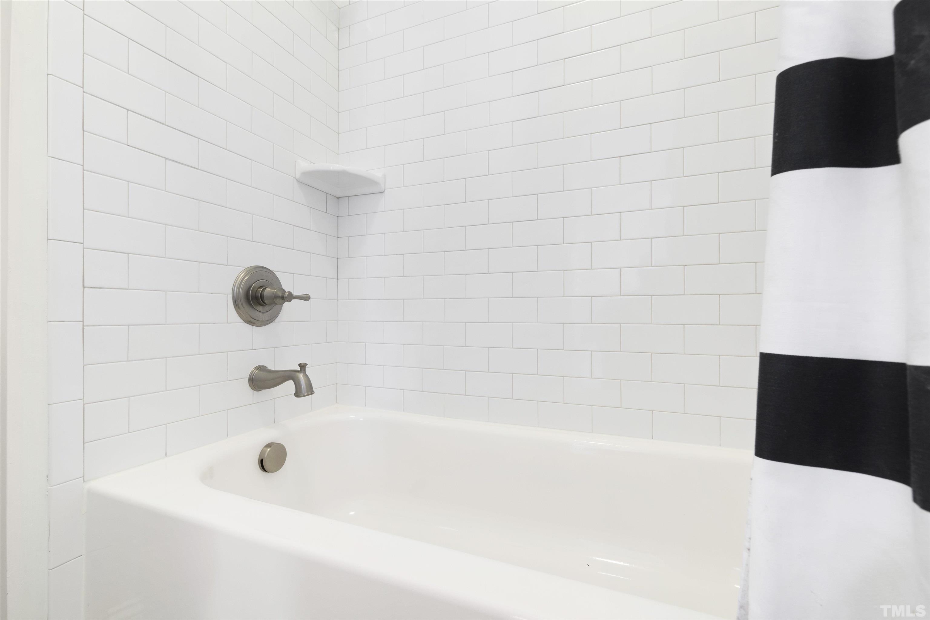 3205 Plantation Road Raleigh, NC 27609 - Photo 28 of 39 a bathroom with a bathtub