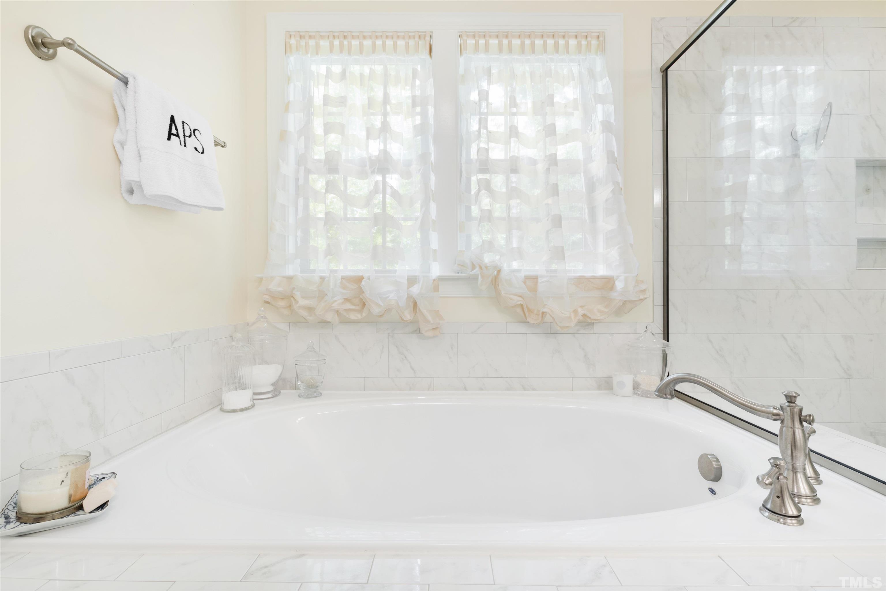 3205 Plantation Road Raleigh, NC 27609 - Photo 29 of 39 a white bath tub sitting in a bathroom
