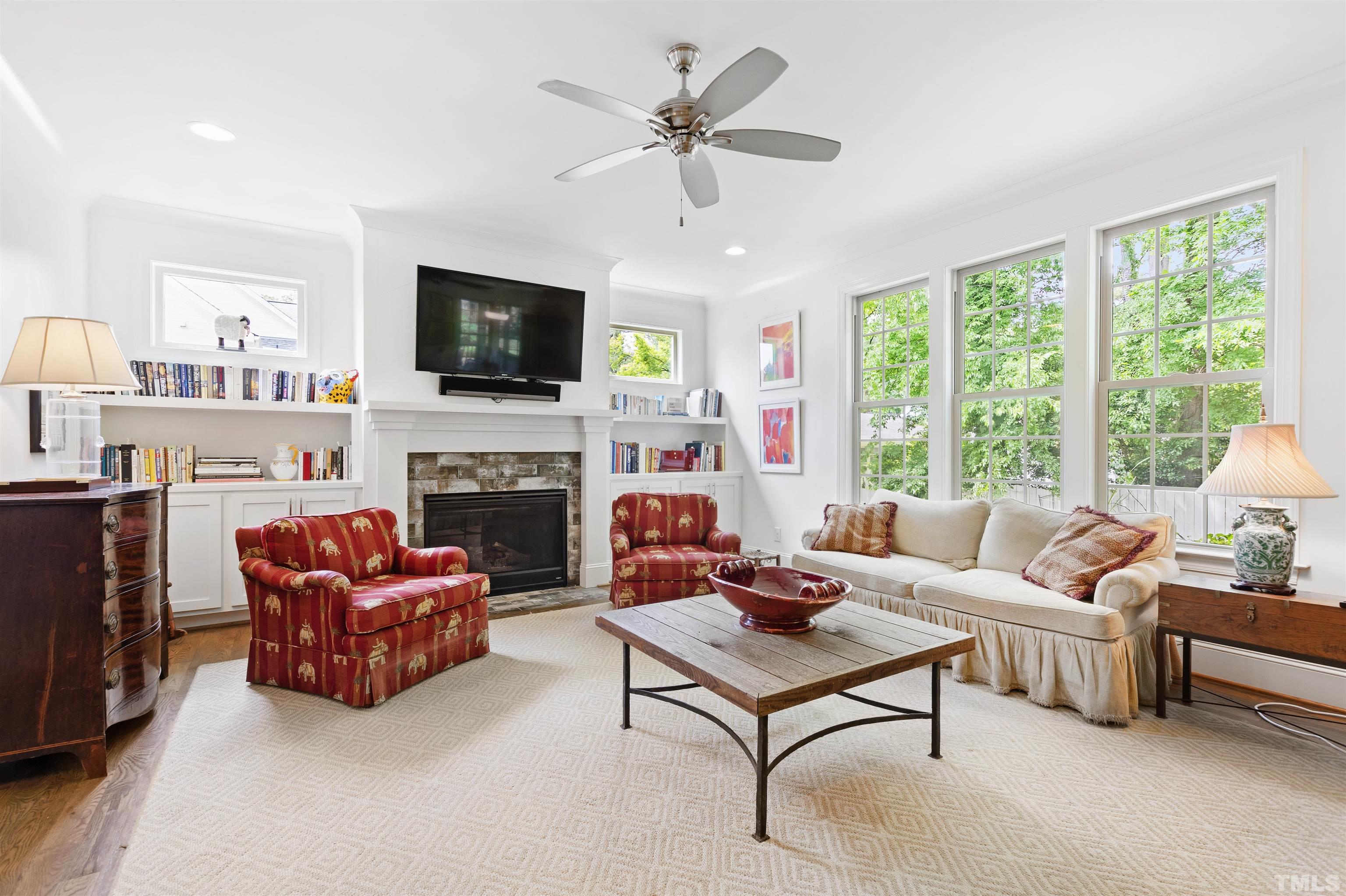 3205 Plantation Road Raleigh, NC 27609 - Photo 10 of 39 a living room with furniture a flat screen tv and a fireplace