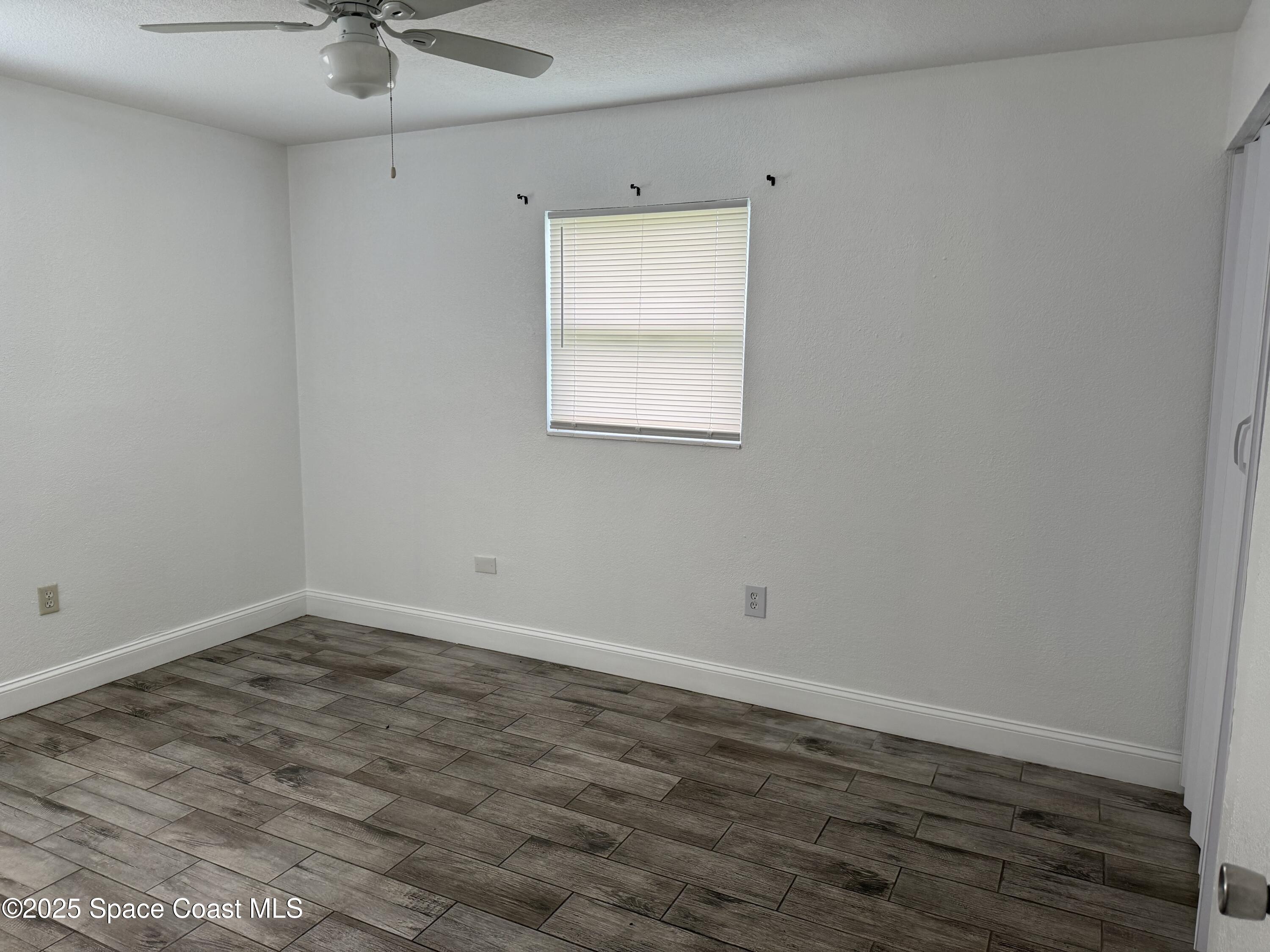2806 Tropic Road, Unit 1 Melbourne, FL 32935 - Photo 3 of 7 an empty room with a window
