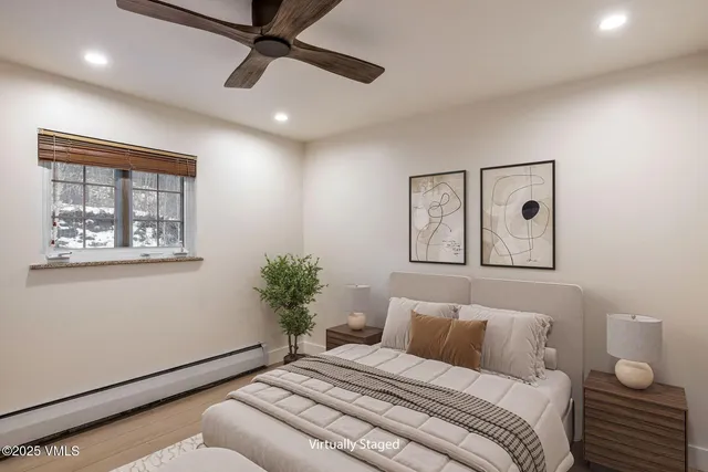 a bedroom with a bed and a painting on the wall