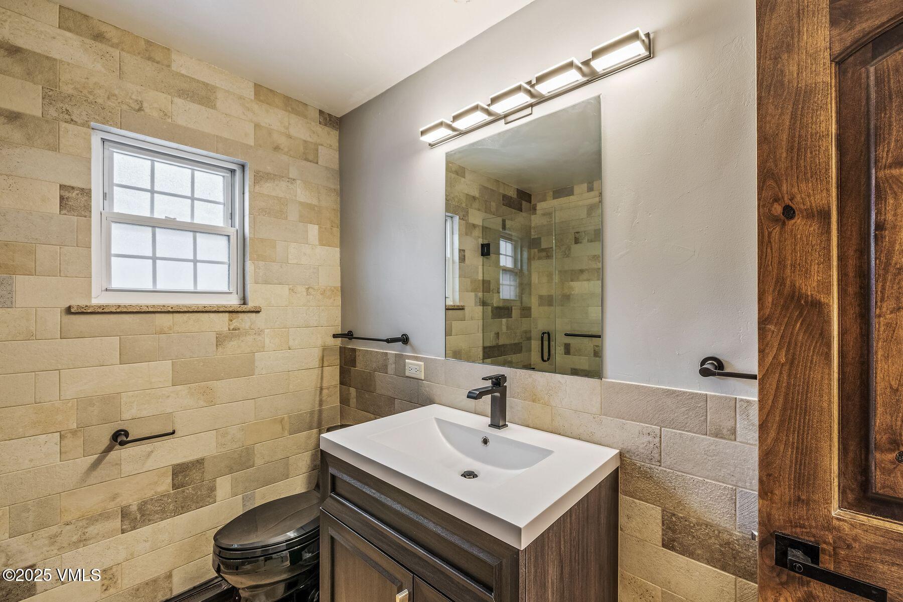 4133 Spruce Way, Unit 6 Vail, CO 81657 - Photo 10 of 11 a bathroom with a sink a toilet and shower