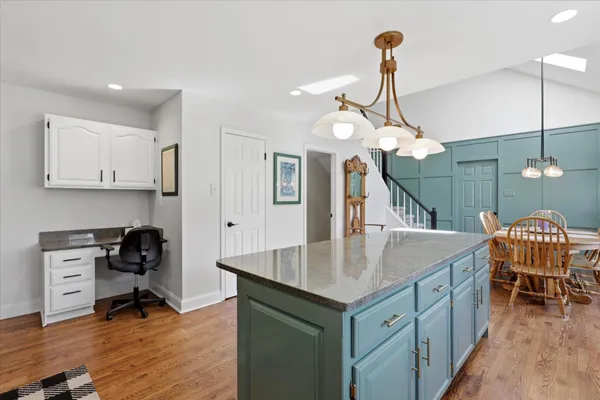 a kitchen with a table chairs and a chandelier