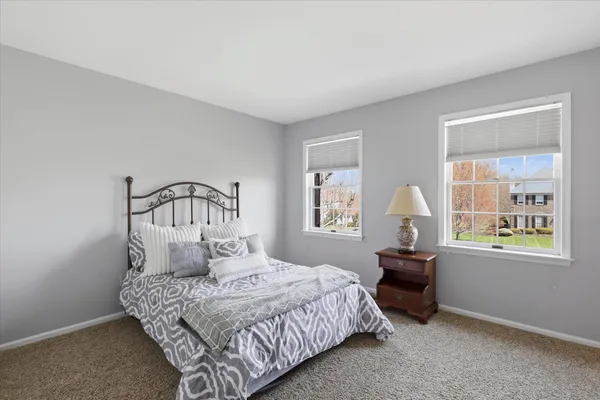 a bedroom with bed and a window