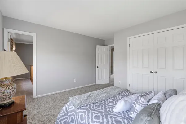 a bedroom with a bed and a mirror