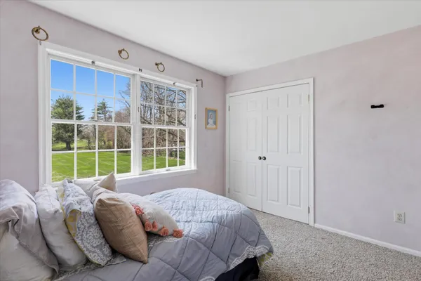 a bed sitting in a bedroom next to a window