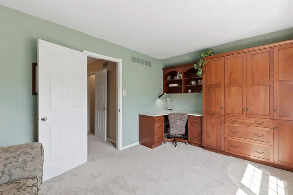 a view of workspace with furniture and cabinet