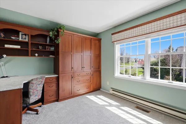 a workspace with furniture and a window