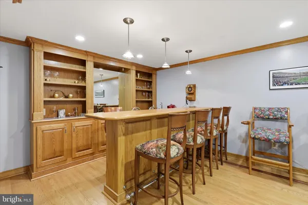 a kitchen with stainless steel appliances kitchen island granite countertop a table and chairs in it