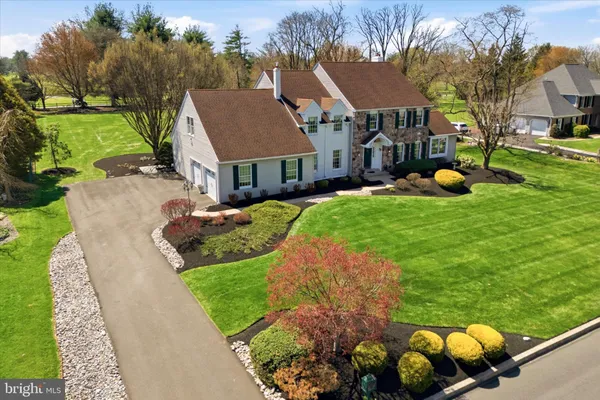 an aerial view of a house with a swimming pool and lake view