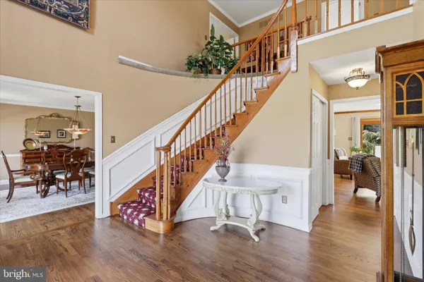a view of entryway and hall with wooden floor