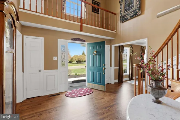 a dinning room with wooden floor and stairs