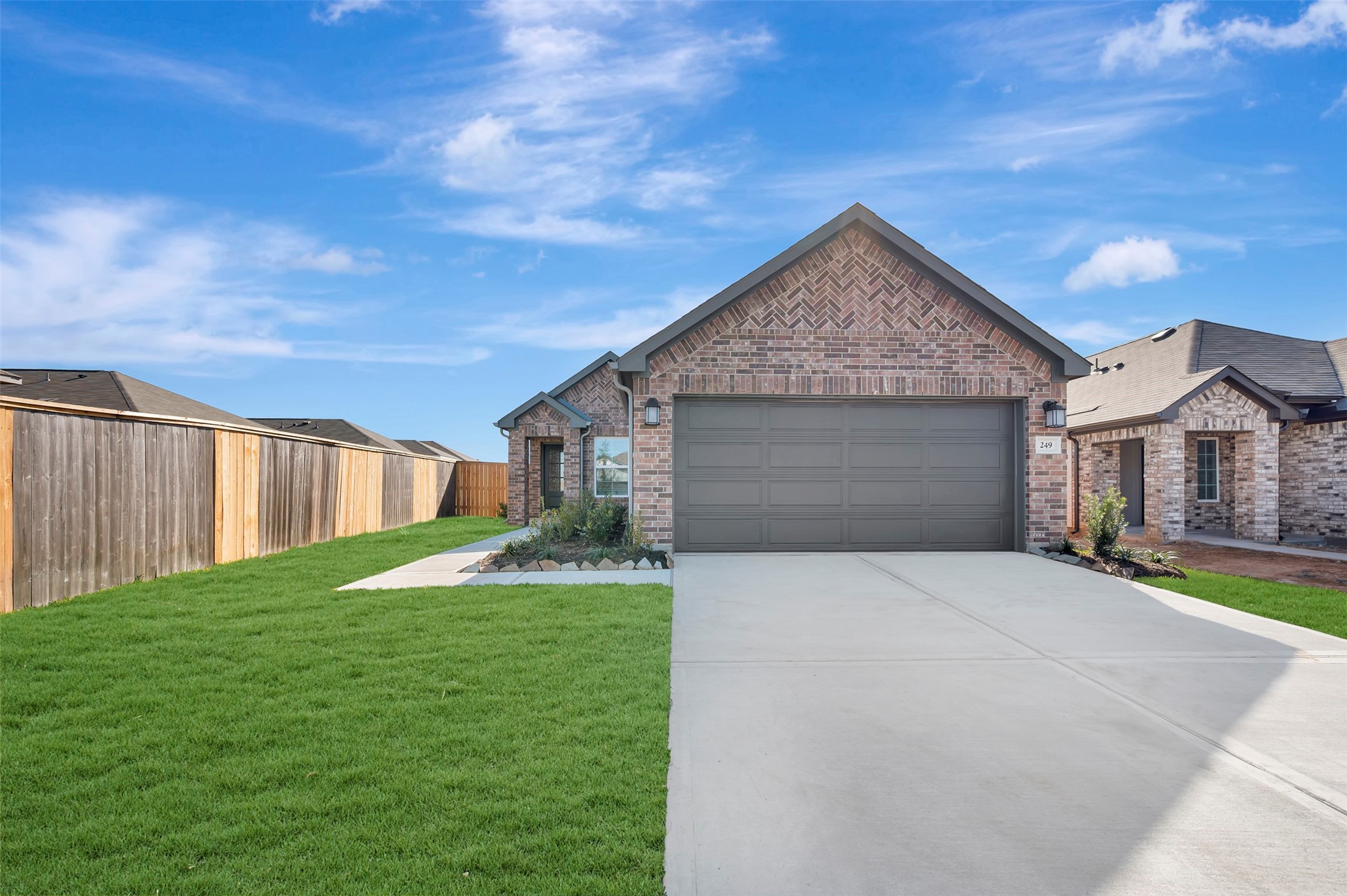 249 Hazy Pnes Lane Willis, TX 77378 - Photo 1 of 38 a front view of a house with yard and garage
