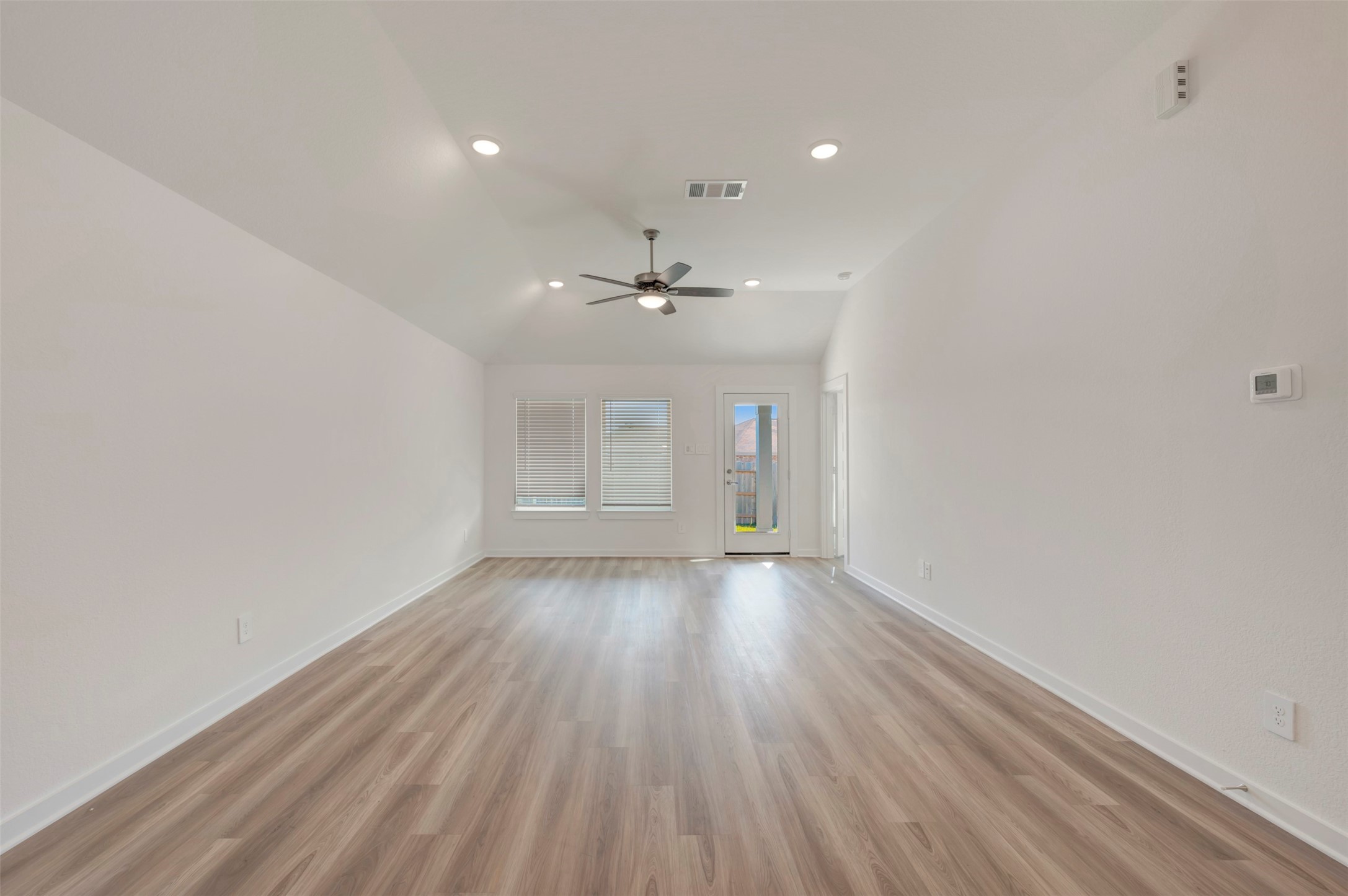 249 Hazy Pnes Lane Willis, TX 77378 - Photo 3 of 38 wooden floor in an empty room with a window