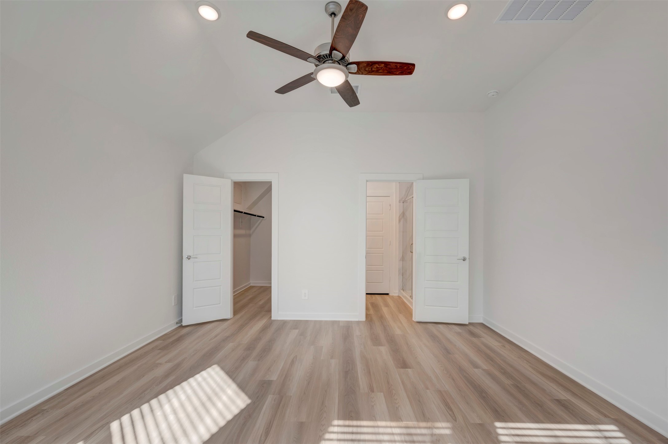 249 Hazy Pnes Lane Willis, TX 77378 - Photo 4 of 38 a view of empty room with wooden floor and fan