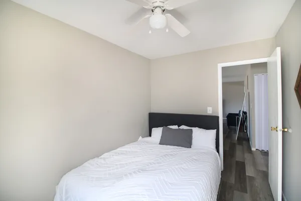 a bedroom with a bed and a chandelier