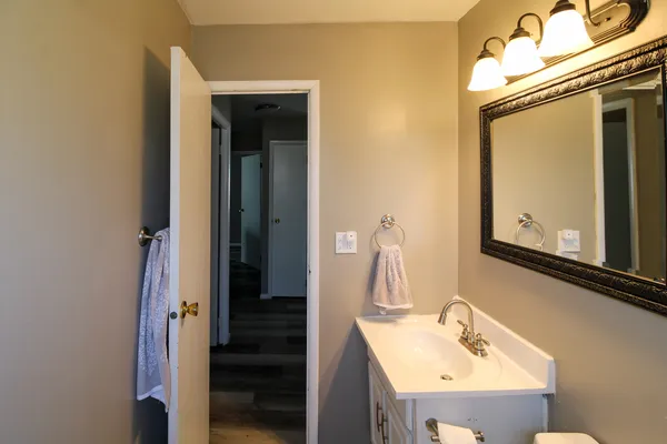 a bathroom with a sink vanity and mirror