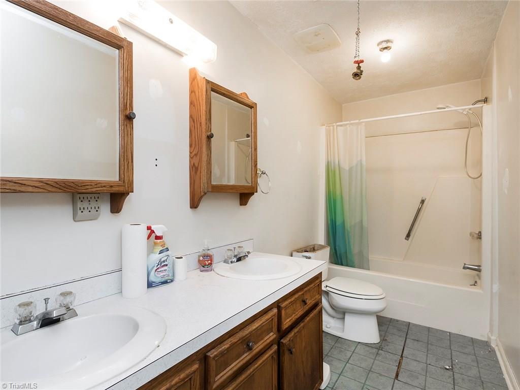 8564 Benbow-Merrill Road Oak Ridge, NC 27310 - Photo 13 of 20 Bathroom with dbl vanity and shower/tub combo.