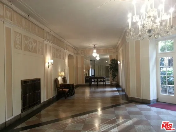 a lobby with furniture and a chandelier