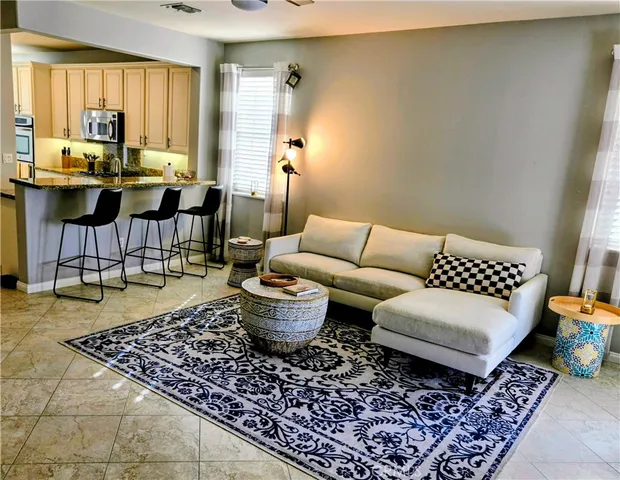 a view of a patio with table and chairs with potted plants